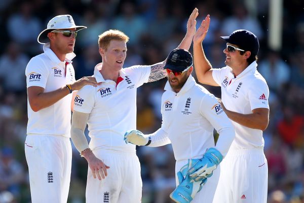 Ben Stokes and Alastair Cook of England celebrate the wicket of Brad Haddin 