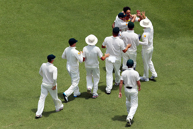 Mitchell Johnson of Australia celebrates with his teammates after taking the wicket of Matt Prior of England on Tuesday