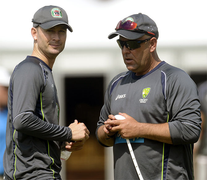 Australia's captain Michael Clarke (left) talks to coach Darren Lehmann during a training session