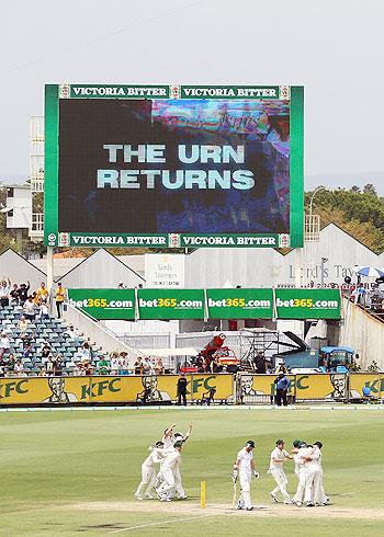 Australian players celebrate after defeating England on Day 5 of the Third Ashes Test at WACA in Perth on Tuesday