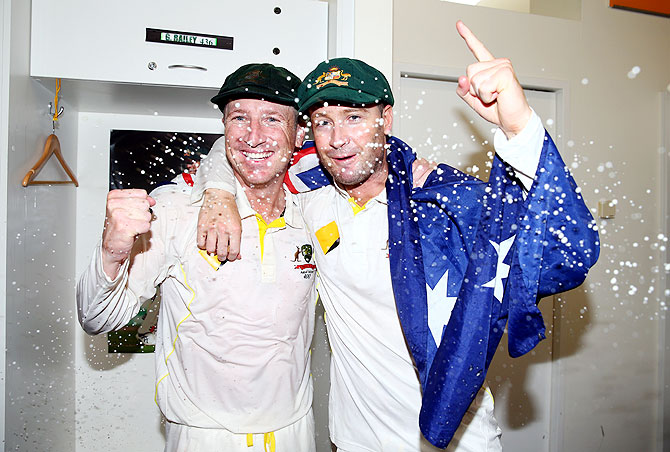 Brad Haddin and Michael Clarke of Australia celebrate victory in the dressing room on Tuesday