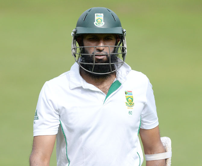 Hashim Amla of South Africa walks off after being dismissed by Ishant Sharma