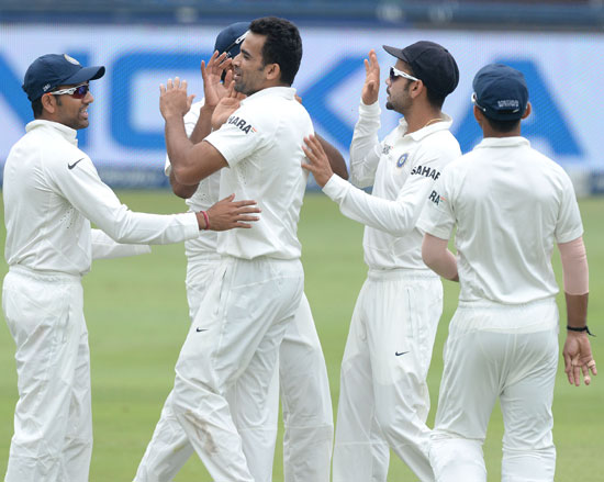Zaheer Khan is congratulated by teammates after taking a wicket