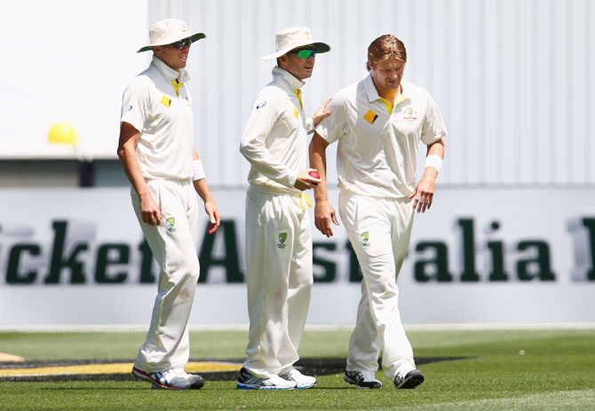 Shane Watson of Australia leaves the ground with a leg injury