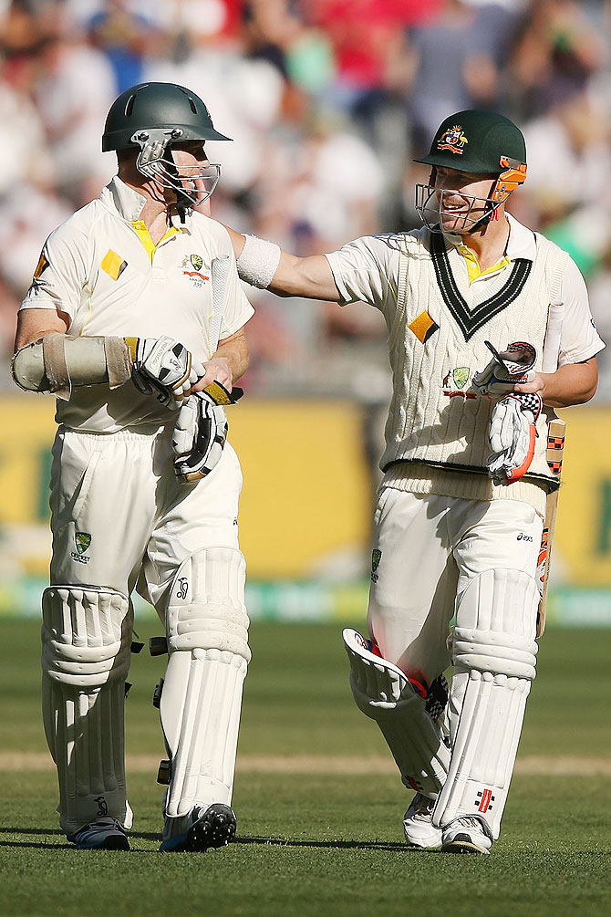 David Warner (right) and Chris Rogers of Australia walk off at the end play on Day 3 on Saturday