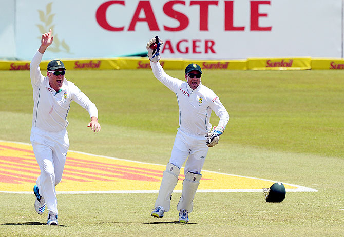 Graeme Smith and AB de Villiers of South Africa celebrate the wicket of Cheteshwar Pujara for 70 runs