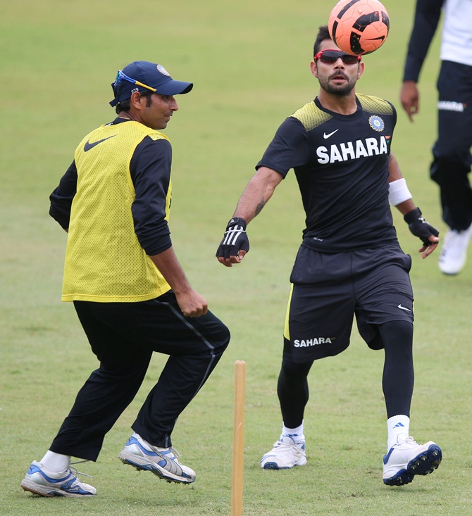 Mohammed Shami (left) and Virat Kohli of India play football during the Indian national cricket team training session