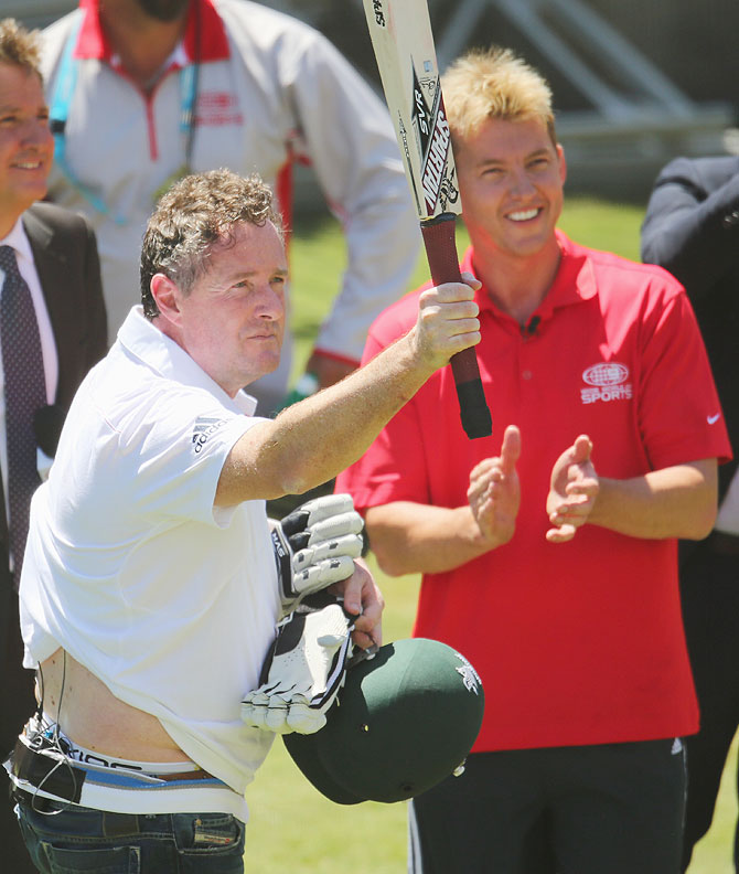 Piers Morgan salutes the crowd after facing deliveries from former Australian cricketer Brett Lee (right) in the nets during day two of the Fourth Ashes Test at Melbourne Cricket Ground on Friday