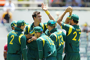 Mitchell Starc is congratulated by team-mates after bowling Kieron Pollard of the West Indies during the first game of the Commonwealth Bank ODI series at WACA on Friday