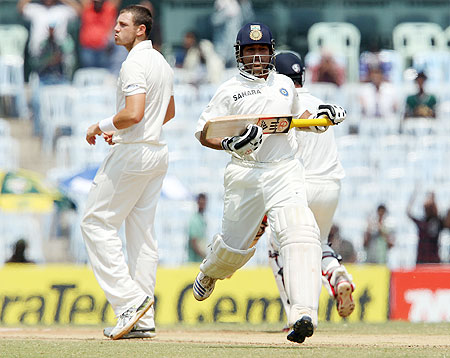 India's Sachin Tendulkar runs past James Pattinson on Day 2 of the 1st Test at the MA Chidambaram Stadium in Chennai on Saturday