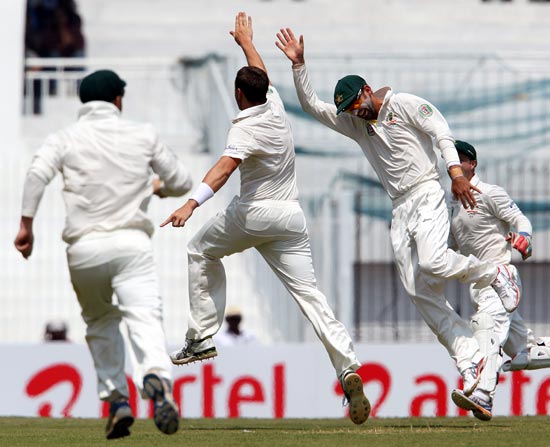 The Australian team celebrate the wicket of Virender Sehwag