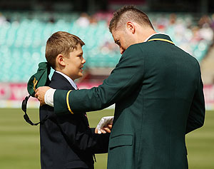 Australian captain Michael Clarke is presented with the handkerchief of the late Tony Greig by his son Tom Greig on Day 1 of the third Test between Australia and Sri Lanka at Sydney Cricket Ground on Thursday