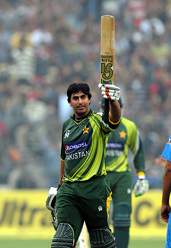 Nasir Jamshed raises his bat after scoring a second successive hundred