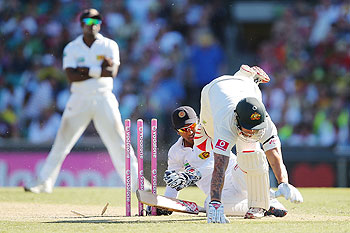 Mitchell Johnson collides with Dinesh Chandimal of Sri Lanka during day two of the Third Test match between Australia and Sri Lanka at Sydney Cricket Ground on Friday
