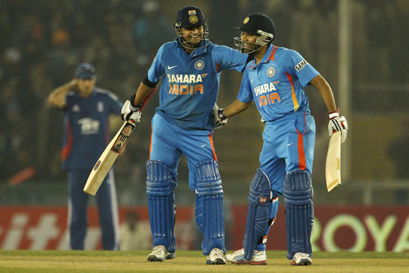 Suresh Raina of India and Rohit Sharma of India celebrate their fifty partnership during the 4th ODI in Mohali