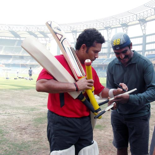 Sachin Tendulkar signs autographs after the nets session