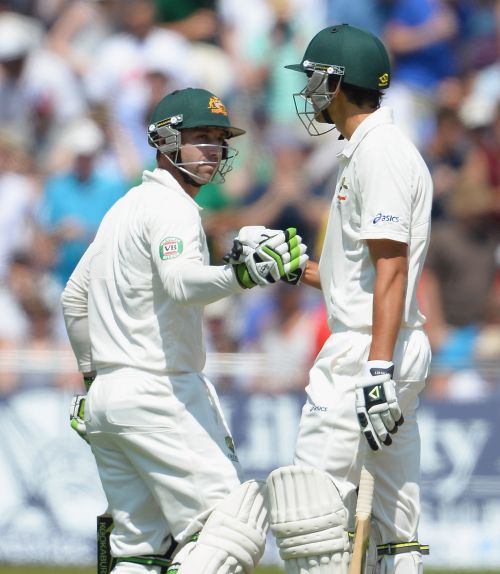 Phil Hughes (L) and Ashton Agar of Australia shake hands after both reaching half centuries during day two of the 1st Investec Ashes Test match between England and Australia at Trent Bridge Cricket Ground