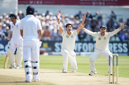 Mitchell Starc appeals successfully for the wicket of Jonathan Trott after a referral. Phil Hughes is on the right.