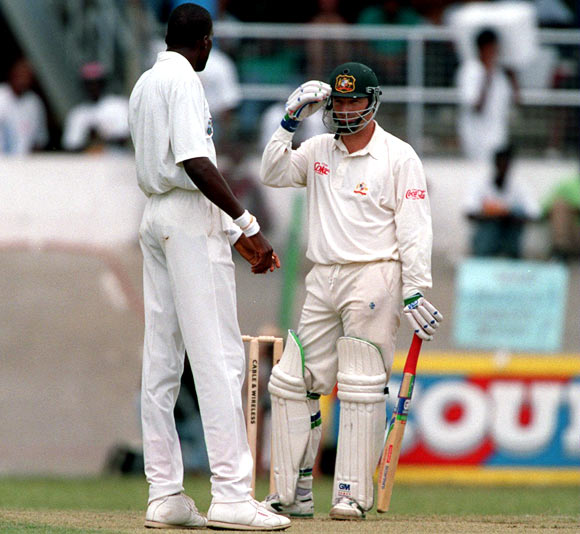 Steve Waugh (right) speaks to Curtley Ambrose