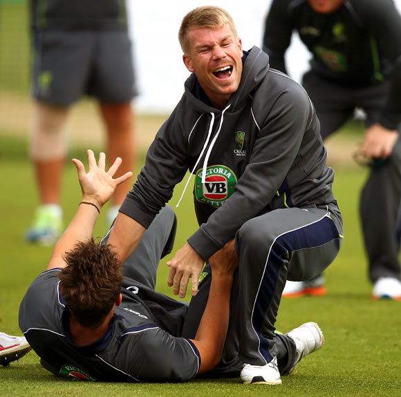 David Warner jokes with a team-mate during an Australian training session.