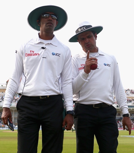 Umpires Kumar Dharmasena and Aleem Dar walk off the field at stumps on day three of the 1st Ashes Test at Trent Bridge
