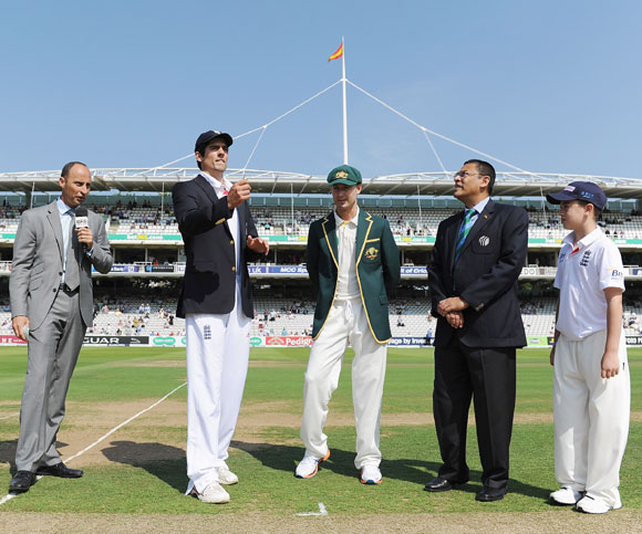 Alastair Cook of England tosses the coin with Australian captain Michael Clarke, commentator Nasser Hussain (left) and match referee Ranjan Madugalle during day one of the 2nd Ashes Test at Lord's