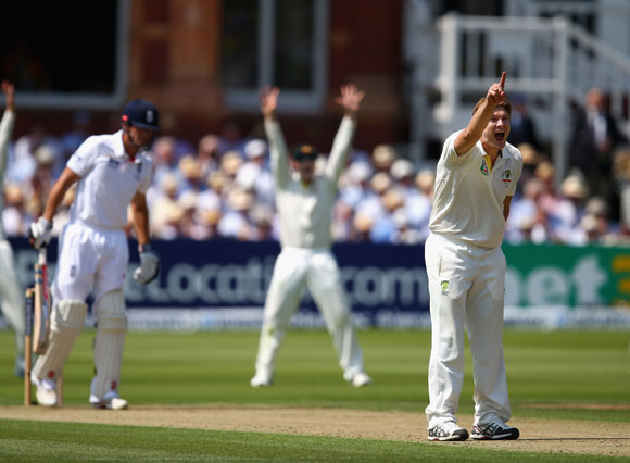 Shane Watson of Australia celebrates after taking the wicket of Alastair Cook of England