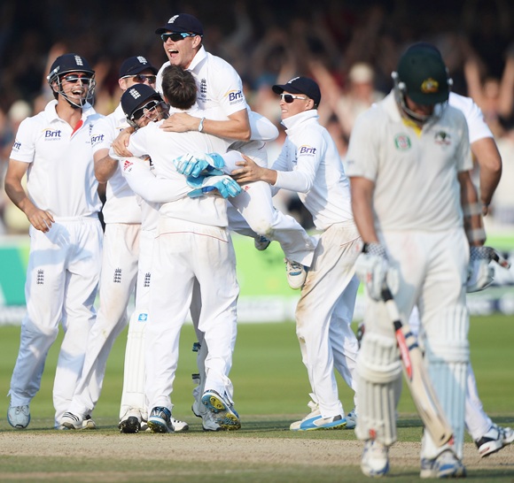 Graeme Swann is mobbed by teammates after taking the final wicket, of James Pattinson