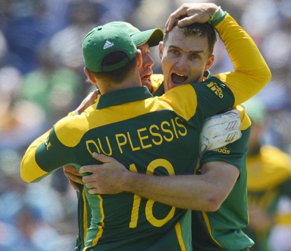 South Africa's Ryan McLaren (R) is congratulated after dismissing India's Dinesh Karthik
