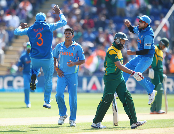 Hashim Amla of South Africa walks as Umesh Yadav (second left) of India captures his wicket