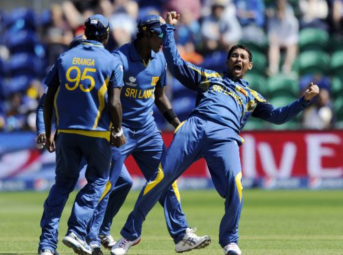 Sri Lanka's Tillakaratne Dilshan (R) celebrates after the dismissal of New Zealand's James Franklin during the ICC Champions Trophy group A cricket match at the Cardiff Wales Stadium
