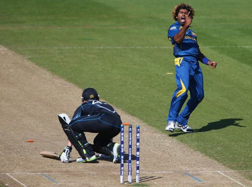 Lasith Malinga (R) of Sri Lanka celebrates bowling Brendon McCullum