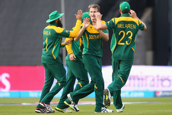 Chris Morris (C) of South Africa celebrates taking the wicket of Muhammad Hafeez of Pakistan with Hashim Amla (L) and Ryan McLaren (R) during the ICC Champions Trophy Group B match