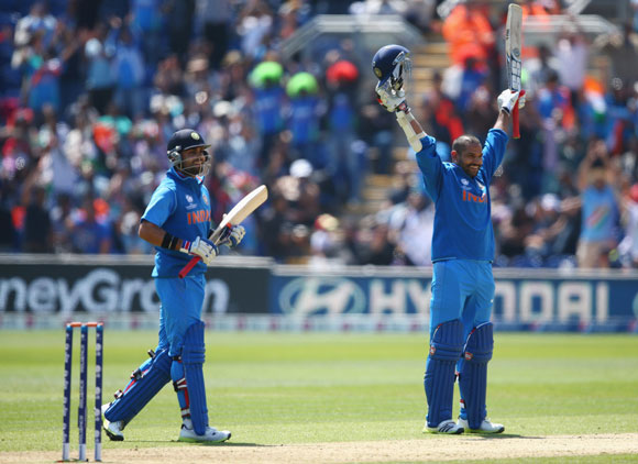 Shikhar Dhawan (R) of India celebrates reaching his century against South Africa