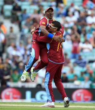  Sunil Narine is congratulated by Dwyane Bravo after he takes a wicket