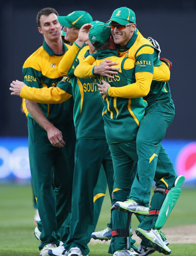 AB de Villiers the captain of South Africa lifts Faf Du Plessis (R) off his feet after catching Kamran Akmal of Pakistan