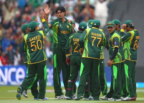 Mohammad Irfan celebrates with teammates after taking a wicket