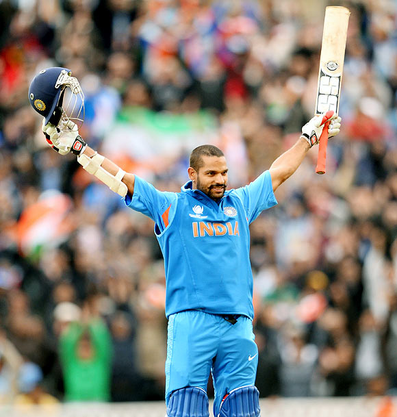 Shikhar Dhawan celebrates after completing his century
