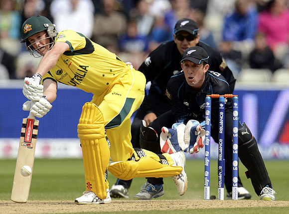 Australia's George Bailey (left) hits out watched by New Zealand's Ross Taylor and Luke Ronchi (front R) during the ICC Champions Trophy group A match at Edgbaston