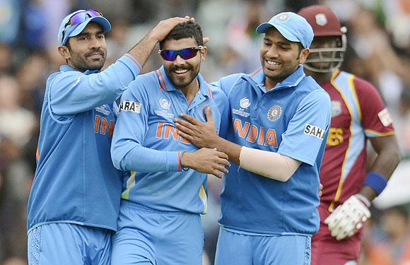 India's Ravindra Jadeja (centre) is congratulated by teammates Dinesh Karthik (left) and Rohit Sharma after dismissing West Indies' Ravi Rampaul