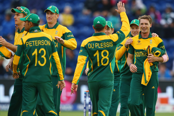 Dale Steyn (R) of South Africa accepts the congratulations from team mates after capturing the wicket of Johnson Charles of West Indies