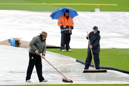 Groundsmen work overtime to get the field ready