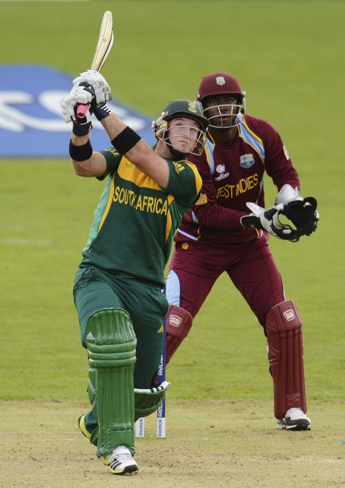 South Africa's Colin Ingram (L) hits a six as West Indies' Johnson Charles looks on