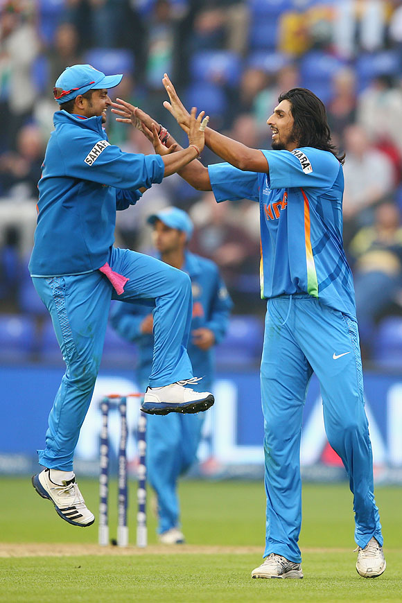 Ishant Sharma celebrates with Suresh Raina (left) after taking the wicket of Thisara Perera of Sri Lanka on Thursday
