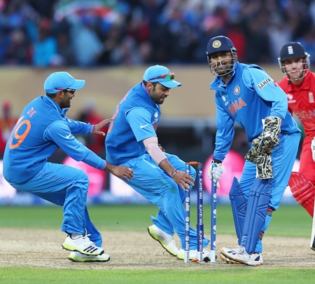 (from left) Dinesh Karthik, Suresh Raina and MS Dhoni pick a stump as souvenirs after victory is clinched