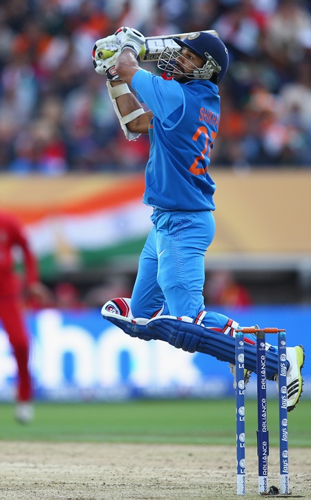 Shikhar Dhawan of India hits a six over backward point off the bowling of Stuart Broad