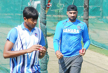 Harbhajan Singh and a local bowler at the nets session in Hyderabad on Thursday