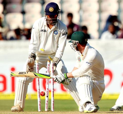 Phil Hughes is clean bowled by R Ashwin