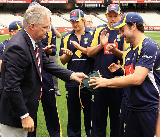 Ed Cowan of Australia is presented with his Baggy Green Cap by former cricketer Dean Jones