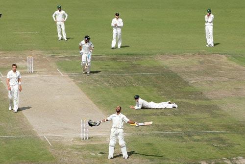 Shikhar Dhawan acknowledges the cheers from the Mohali crowd after scoring the fastest century on Test debut -- a century off only 85 balls at a strike rate of 117.64, March 16, 2013. Photograph: BCCI